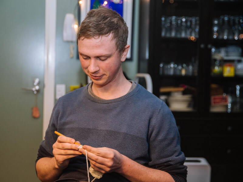 A man starting a crochet chain.